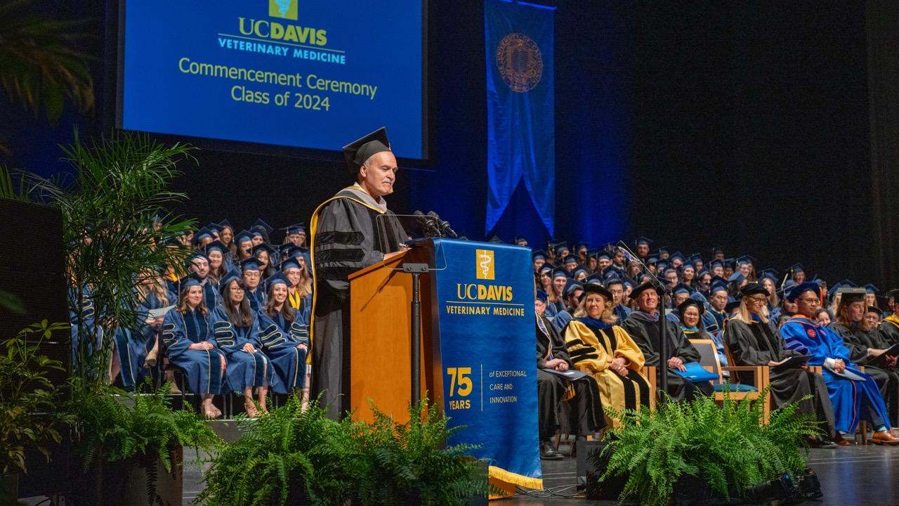 Dr. Jose Emilio Esteban at the podium of the 2024 School of Veterinary Medicine Commencement Ceremony