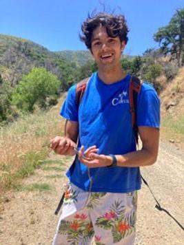 Person smiling and holding a small snake.