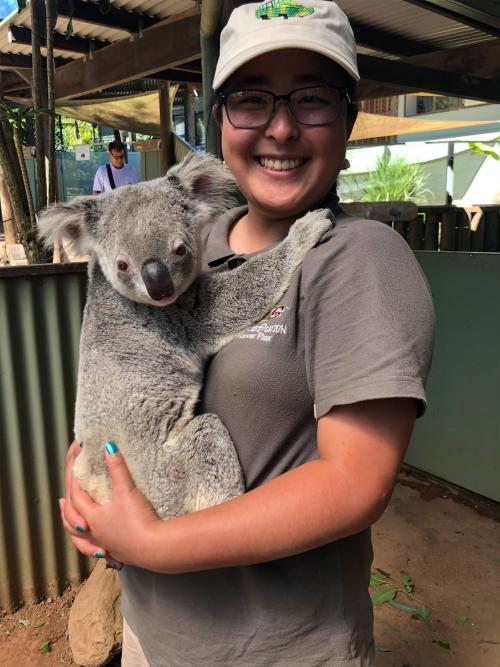 Person holding a koala.