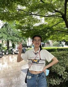 Person standing outside smiling.