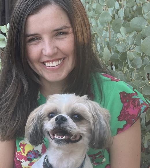 Person posing with dog.