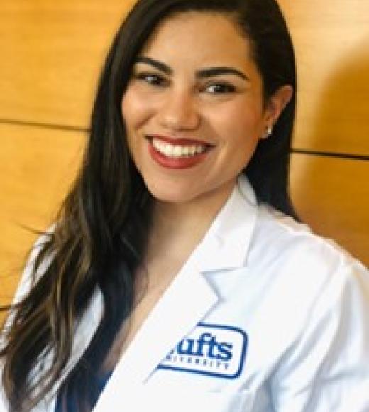 Person in lab coat smiling.